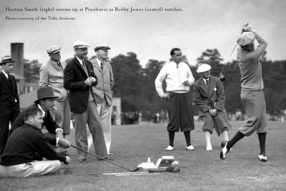 Bobby Jones, seated, watches as Horton Smith hits practice shots on Maniac Hill at Pinehurst.